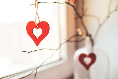 Decoration for Valentine's Day with ornaments in the form of hearts on a branch.の写真素材