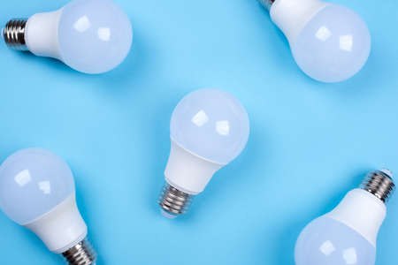 Several LED bulb on blue background. Saving energy concept. Ftat lay. Top view.