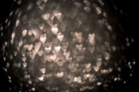 Background with silver bokeh in the shape of a heart. Valentines day concept.の写真素材