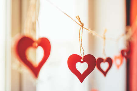 Decoration for Valentines Day with ornaments in the form of hearts on a branch.の写真素材