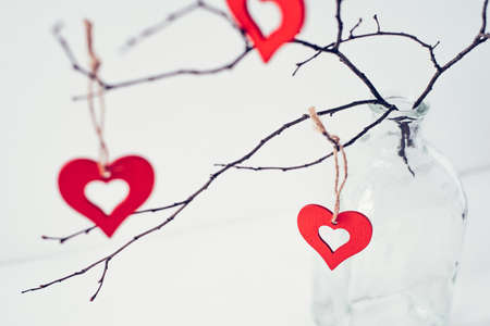 Decoration for Valentines Day with ornaments in the form of hearts on a branch.の写真素材