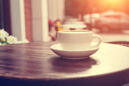 View of a summer terrace cafe with cup of cappuccino on the table.の写真素材
