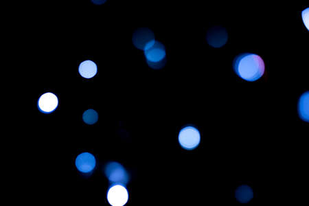 Black abstract background with blue bokeh. Color of year 2020.の写真素材