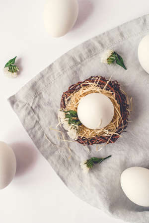 Light Easter background with white Easter eggs. Flat lay, top view.の写真素材