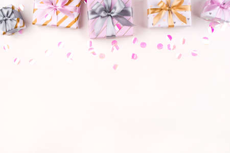 Set of gift boxes with bows and confetti on a white background. Flat lay composition. Birthday, christmas, wedding or another holiday concept.の写真素材