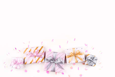Set of gift boxes with bows and confetti on a white background. Flat lay composition. Birthday, christmas, wedding or another holiday concept.の写真素材
