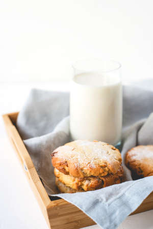 Stacked cookies on a linen napkin and a glass of milk. Close up.の写真素材