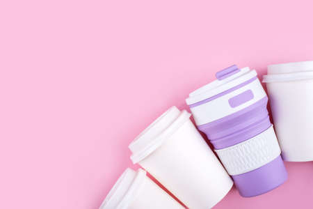 Reusable coffee cup vs disposable cups. Pink background. Zero waste concept. Copy space for your text.の写真素材