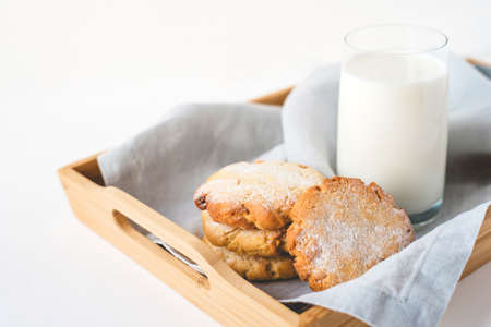 Stacked cookies on a linen napkin and a glass of milk. Close up.の写真素材