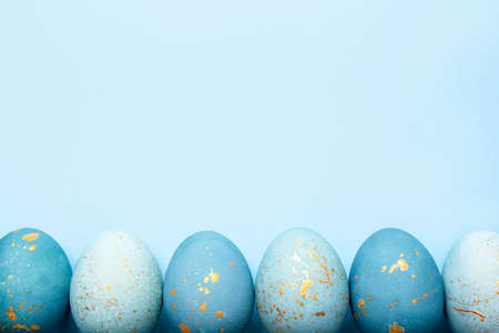 Easter frame of eggs painted in blue color. Flat lay, top view. Copy space for text.の写真素材
