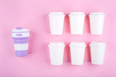Reusable coffee cup vs disposable cups. Pink background. Zero waste concept.の写真素材