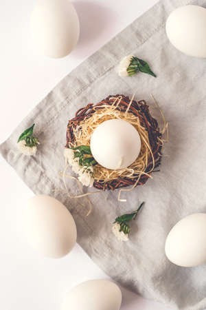 Light Easter background with white Easter eggs. Flat lay, top view.の写真素材