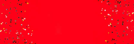 Golden and silver stars on red background. Flat lay, top view.の写真素材