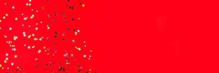 Golden and silver stars on red background. Flat lay, top view.の写真素材