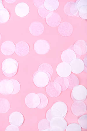 White confetti on pink background. Flat lay, top view.の写真素材