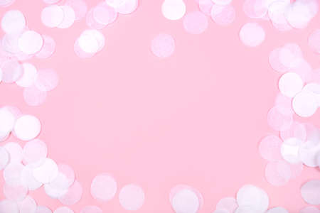 White confetti on pink background. Flat lay, top view. Copy space for text.の写真素材