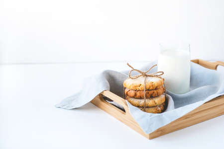 Stacked cookies on a linen napkin and a glass of milk. Close up.の写真素材