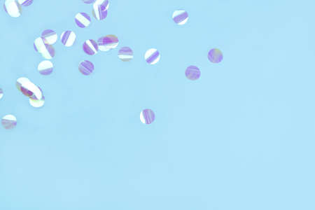 Pearl confetti on blue background. Flat lay, top view.の写真素材