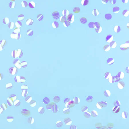 Pearl confetti on blue background. Flat lay, top view.の写真素材