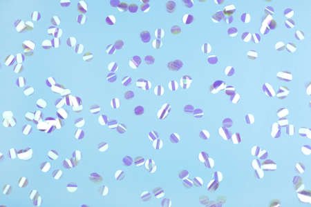 Pearl confetti on blue background. Flat lay, top view.の写真素材