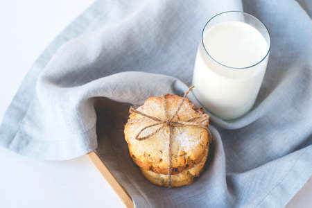 Stacked cookies on a linen napkin and a glass of milk. Close up.の写真素材