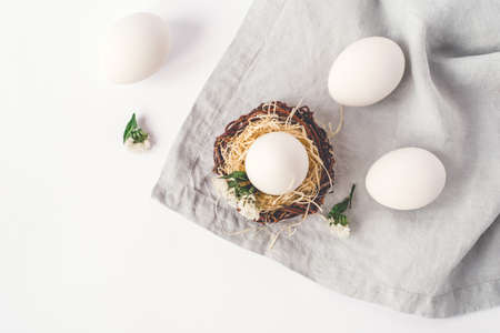 Light Easter background with white Easter eggs. Flat lay, top view.の写真素材