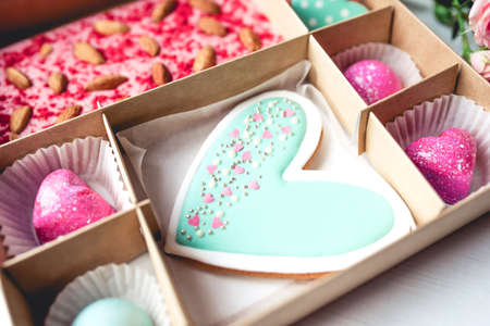 Gift set with hand made sweets in a box on a white table. Flat lay, top view.