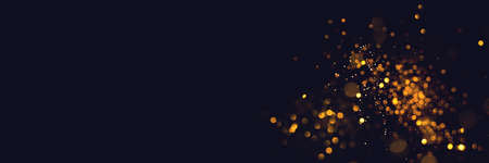 Golden abstract bokeh on black background. Holiday conceptの写真素材