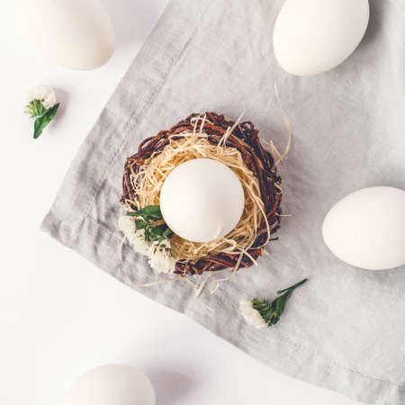 Light Easter background with white Easter eggs. Flat lay, top view.の写真素材