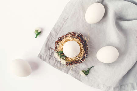 Light Easter background with white Easter eggs. Flat lay, top view.の写真素材