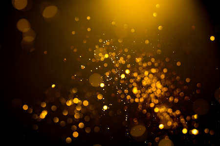 Golden abstract bokeh on black background. Holiday conceptの写真素材