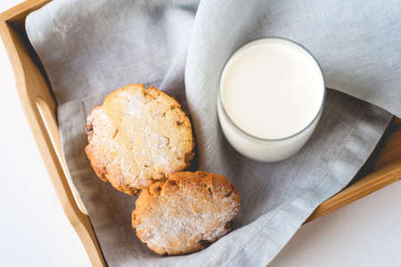 Stacked cookies on a linen napkin and a glass of milk. Close up. Top view.の写真素材