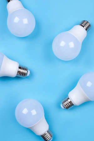 Several LED bulb on blue background. Saving energy concept. Ftat lay. Top view.の写真素材