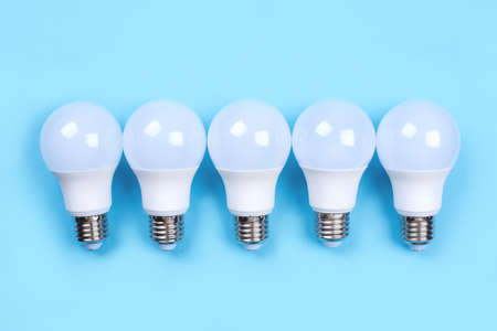 Five LED bulbs on blue background. Saving energy concept. Ftat lay. Top view.の写真素材