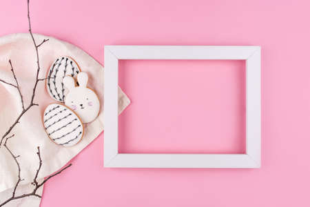 Easter eggs and bunny cookies on pink background. Place for your text. Spring holiday.