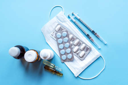 Tablets, pack of medicines with medicine bottles on a blue background. Pharmacy theme.