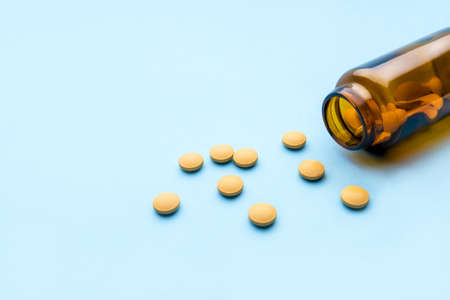Pharmaceutical medicine tablets and bottle on blue background for medical concept.の写真素材
