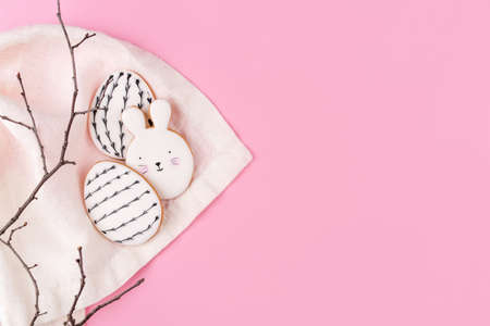 Easter eggs and bunny cookies on pink background. Place for your text. Spring holiday.