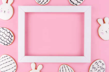 Easter eggs and bunny cookies on pink background. Place for your text. Spring holiday.