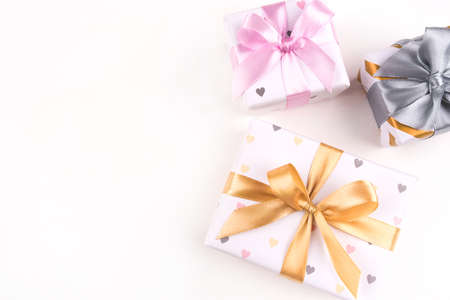 Three gift boxes with bows on a white background. Birthday, christmas, wedding or another holiday concept.の写真素材