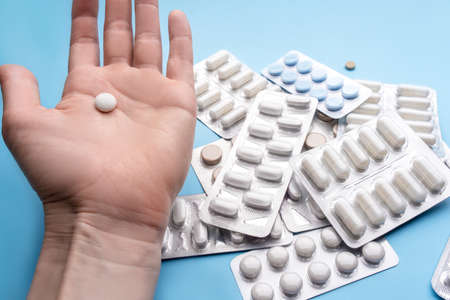 White pill in the hand. Treatment and pharmacy concept. Top view.の写真素材