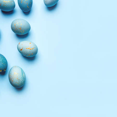 Easter background of eggs painted in blue color. Flat lay, top view.