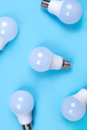 Several LED bulb on blue background. Saving energy concept. Ftat lay. Top view.の写真素材