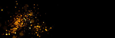 Golden abstract bokeh on black background. Holiday conceptの写真素材