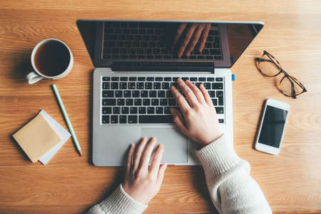 Young woman working in a home office. Remote work concept. Top view.の写真素材