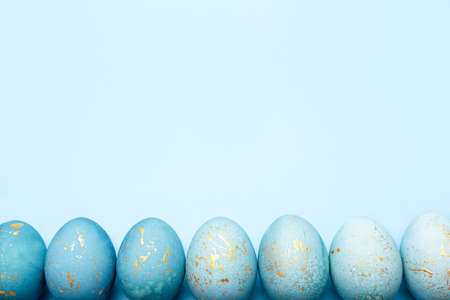 Easter frame of eggs painted in blue color. Flat lay, top view.の写真素材