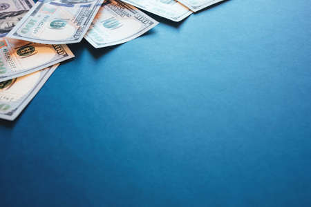 American cash dollars. One Hundred Dollar Banknotes on blue background. Copy space.の写真素材