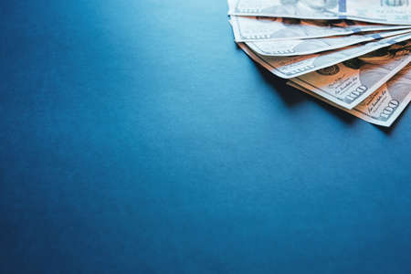 American cash dollars. One Hundred Dollar Banknotes on blue background. Copy space.の写真素材