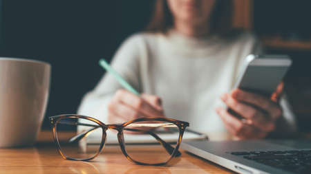 Young woman working in a home office. Remote work concept.の写真素材