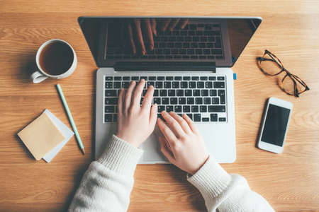 Young woman working in a home office. Remote work concept. Top view.の写真素材